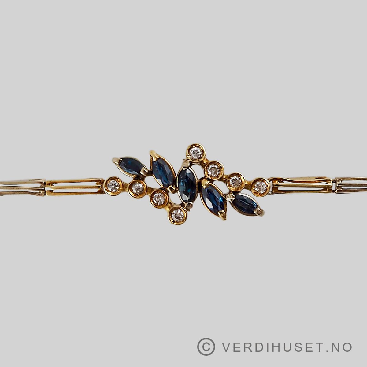 Armbånd i 18 K gull med blå og blanke stener